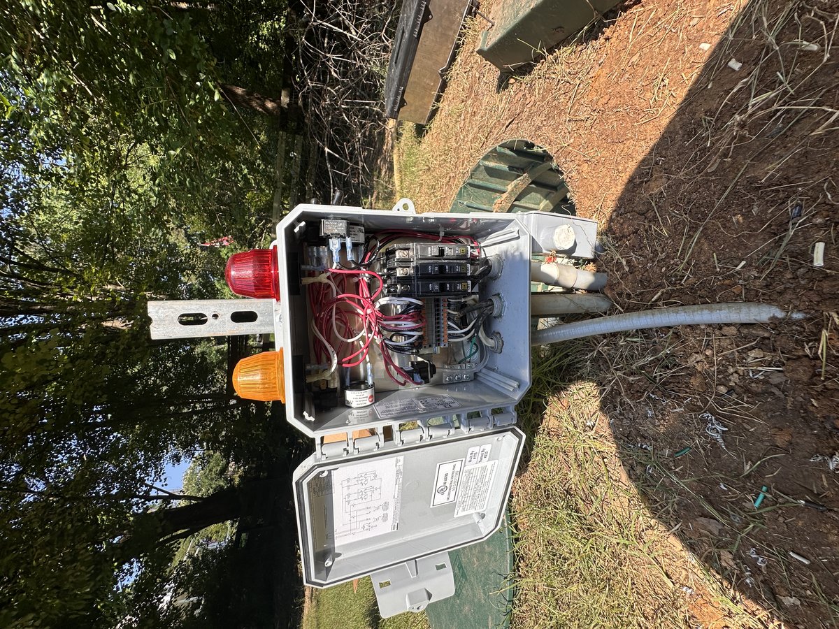 Septic control panel with amber and red alarm beacons lit